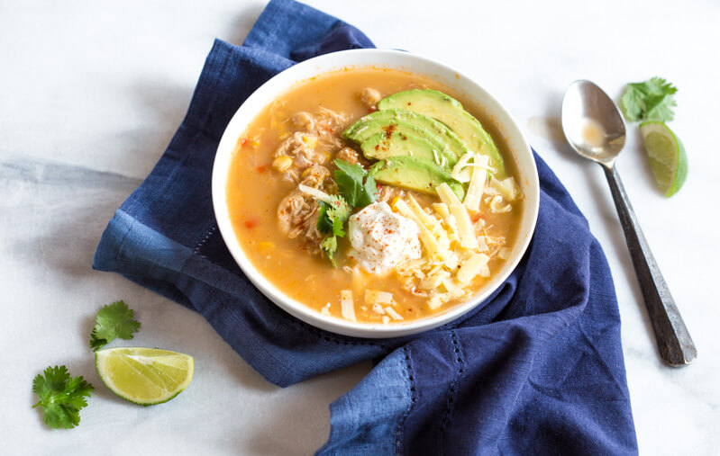 This Slow Cooker Winter White Chicken Chili has a simple ingredient list and is made in the slow cooker!!! Hello convenience. I kept this recipe low maintenance by using pantry staples like canned beans and corn. Talk about a family friendly weeknight meal.