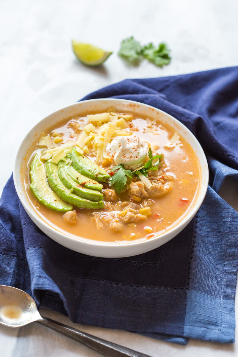 This Slow Cooker Winter White Chicken Chili has a simple ingredient list and is made in the slow cooker!!! Hello convenience. I kept this recipe low maintenance by using pantry staples like canned beans and corn. Talk about a family friendly weeknight meal.