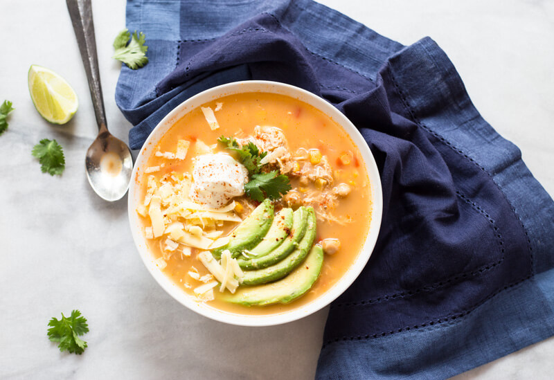 This Slow Cooker Winter White Chicken Chili has a simple ingredient list and is made in the slow cooker!!! Hello convenience. I kept this recipe low maintenance by using pantry staples like canned beans and corn. Talk about a family friendly weeknight meal.