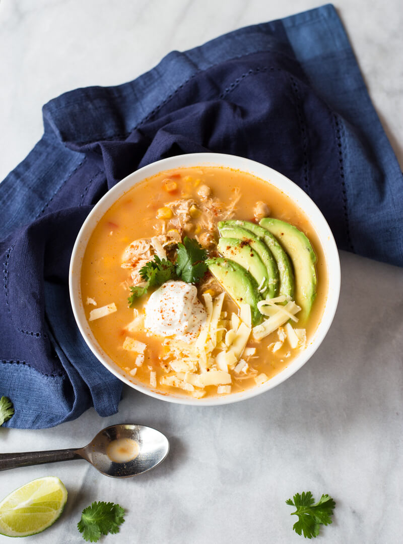 This Slow Cooker Winter White Chicken Chili has a simple ingredient list and is made in the slow cooker!!! Hello convenience. I kept this recipe low maintenance by using pantry staples like canned beans and corn. Talk about a family friendly weeknight meal.