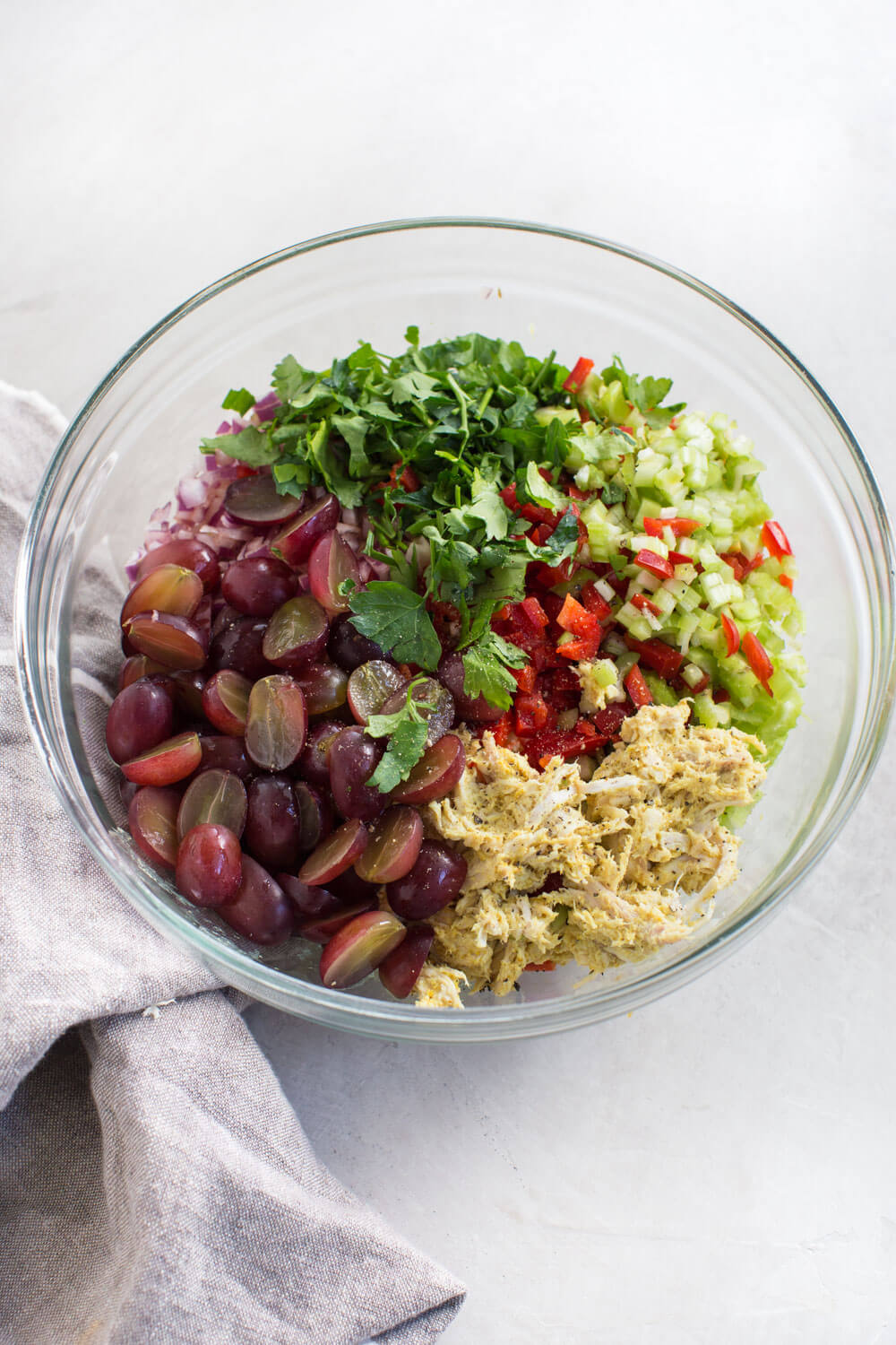 curry chicken salad with grapes, bell pepper, shredded chicken, and parsley 