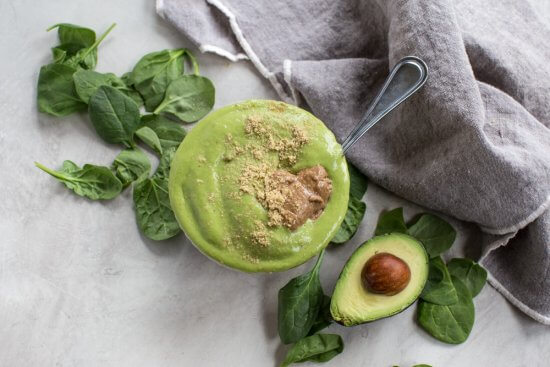 dairy free and vegan energy bowl with spinach, bananas, mango, and avocado 