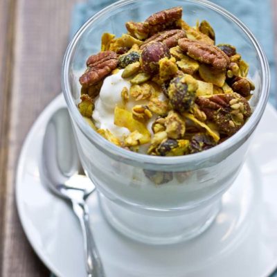 This Maple Pecan & Ginger Granola is savory and sweet with the perfect blend of fall flavors--maple, pecans, & cranberries. It's yummy topped on Greek yogurt and oatmeal!