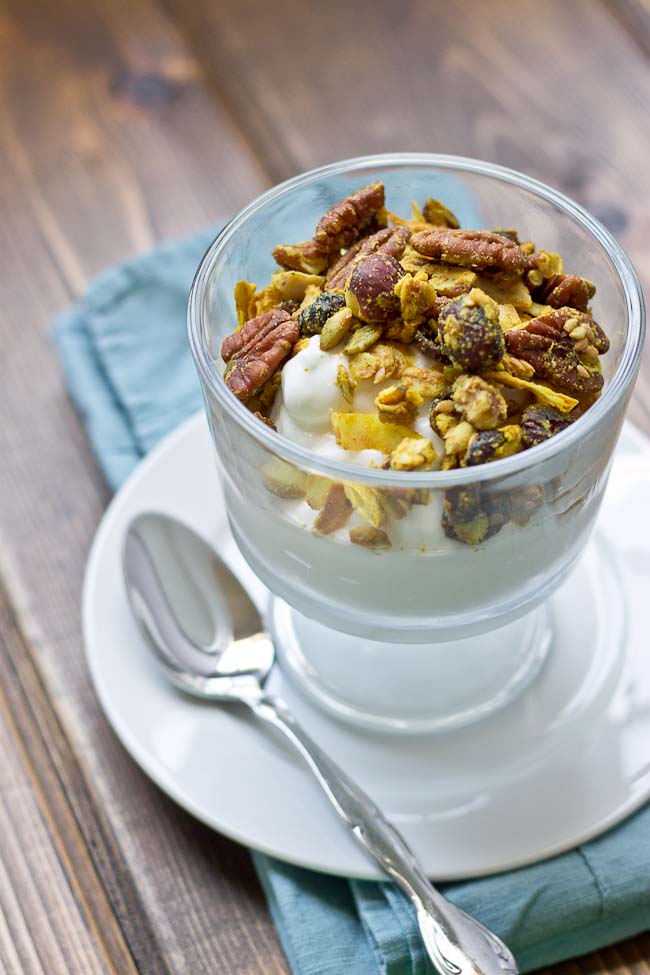 This Maple Pecan & Ginger Granola is savory and sweet with the perfect blend of fall flavors--maple, pecans, & cranberries. It's yummy topped on Greek yogurt and oatmeal!
