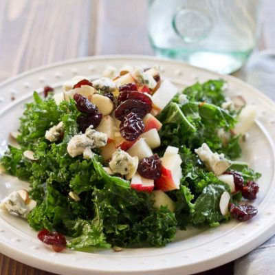 Refreshing Apple & Kale Power Salad topped with tart cherries, almonds, blue cheese, and perfectly dressed with apple maple vinaigrette!