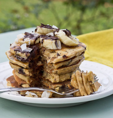 Shaved dark chocolate, smashed banana, coconut flakes, and coconut Greek yogurt = Funky Monkey Pancakes. You will melt.