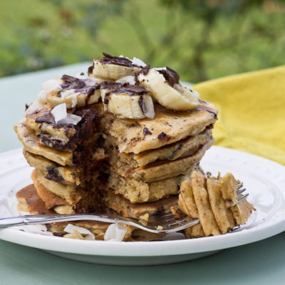 Shaved dark chocolate, smashed banana, coconut flakes, and coconut Greek yogurt = Funky Monkey Pancakes. You will melt.