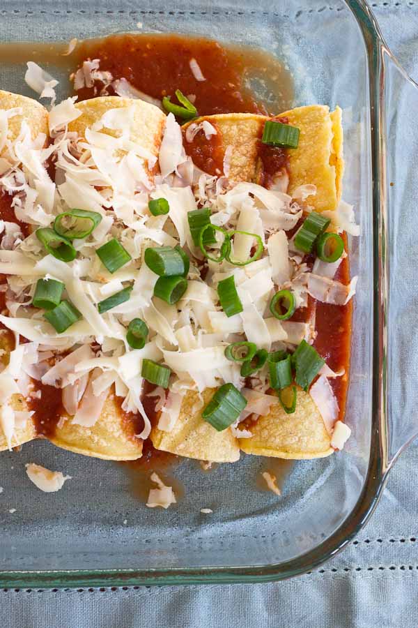 These Healthy Chicken Enchiladas are made with homemade enchilada sauce that you can feel good about. This simple weeknight meal will quickly become a family favorite. Serve with a side of beans and shredded lettuce.