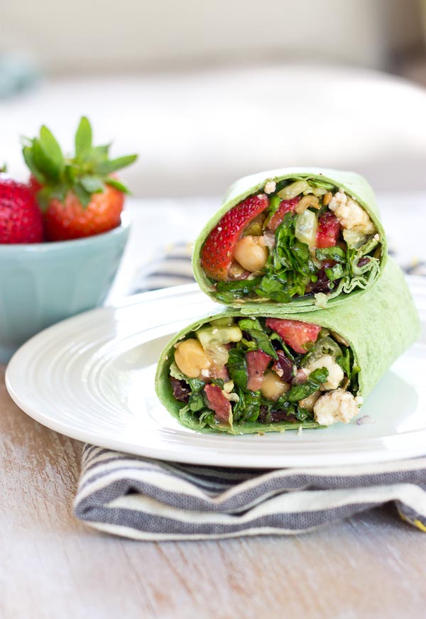 This Strawberry Salad Wrap is bursting with all the goodness of the Spring season. Sweet strawberries, crisp cucumbers and romaine lettuce tossed with a zesty balsamic vinaigrette and folded into a spinach wrap. Can't get enough. 