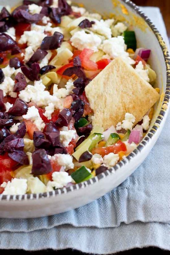This Greek 7 Layer Dip is loaded with only the good stuff-- roasted red pepper hummus and loads of veggies. Perfect appetizer to serve at any party. 