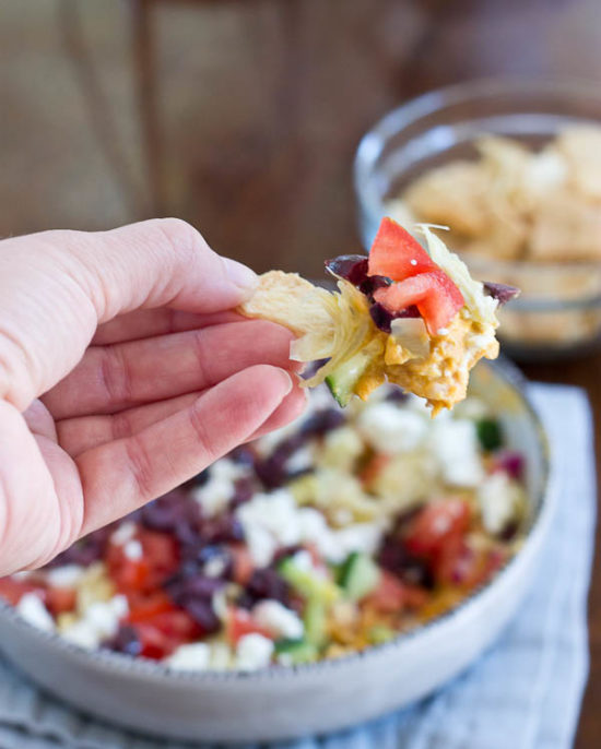 This Greek 7 Layer Dip is loaded with only the good stuff-- roasted red pepper hummus and loads of veggies. Perfect appetizer to serve at any party. 