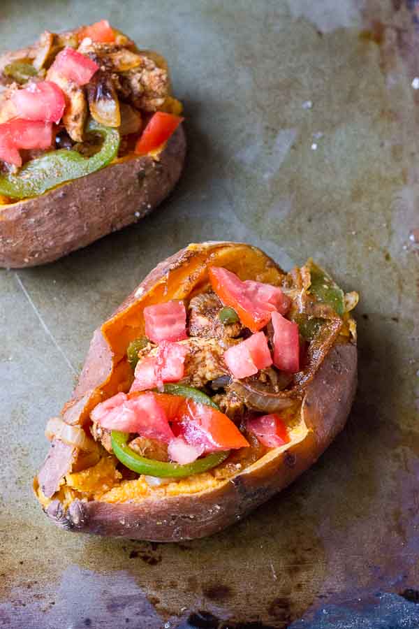 To all the weeknight dinner lovers out there, these Chicken Fajita Stuffed Sweet Potatoes are for you. Fajita grilled chicken, peppers, and onions smothered between a creamy baked sweet potato goodness. This is what we call healthy comfort food. 