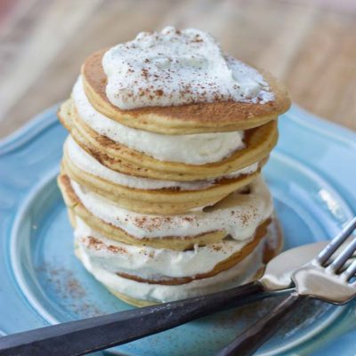 Impress your family and house guests with a stack of festive Eggnog Pancakes topped with creamy Eggnog Whipped Cream. | @KristinaLaRueRD | loveandzest.com