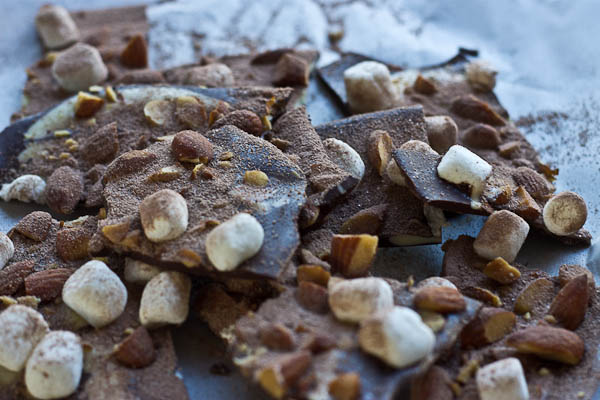 Hot Cocoa Almond Bark... dark chocolate with white chocolate swirl, marshmallows, almonds, and a dusting of hot cocoa.... a super easy recipe to throw together for a holiday party and it's oh so festive!