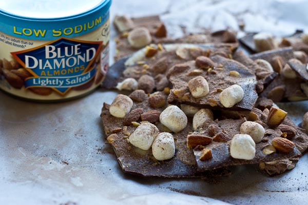 Hot Cocoa Almond Bark... dark chocolate with white chocolate swirl, marshmallows, almonds, and a dusting of hot cocoa.... a super easy recipe to throw together for a holiday party and it's oh so festive!