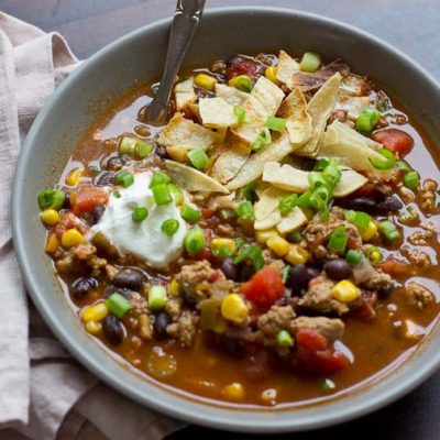 This Turkey Taco Soup is easy peasy to make for a weeknight dinner... a healthy meal the whole family will enjoy. Toss all ingredients into a pot and simmer until you're ready to eat! The toppings are the best part! | @KristinaLaRueRD | www.loveandzest.com