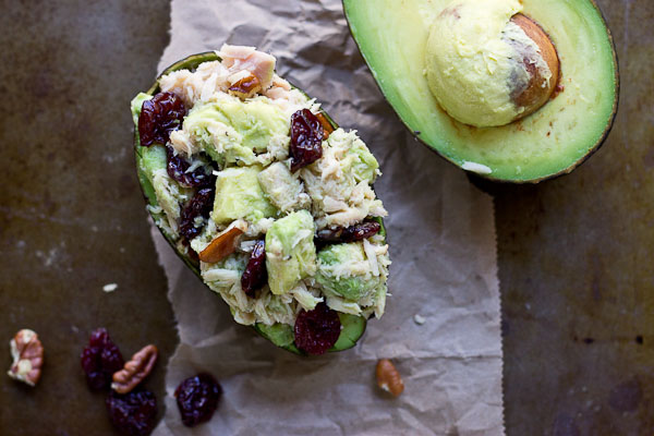 overhead shot of tuna stuffed avocado with tart cherries and chopped pecans 