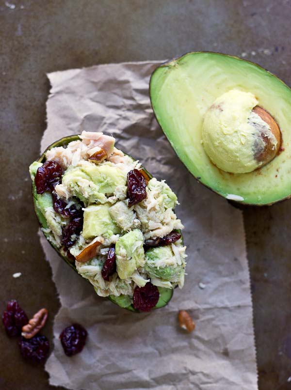 overhead shot of tuna stuffed avocado with tart cherries 