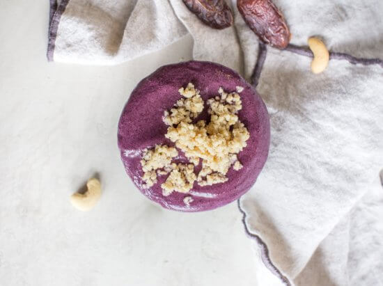 creamy vegan smoothie bowl with blueberries, almond milk, cashews, and dates