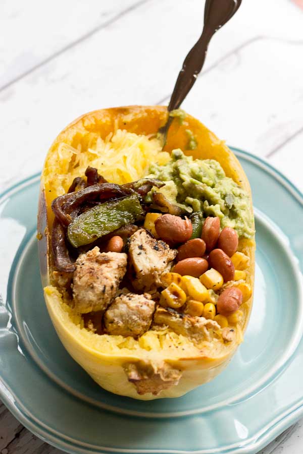 These Chicken Burrito Spaghetti Squash Bowls are protein packed and gluten free. I love this veggie filled take on this popular Mexican dish. Everything is better in a {spaghetti squash} bowl!