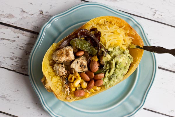 These Chicken Burrito Spaghetti Squash Bowls are protein packed and gluten free. I love this veggie filled take on this popular Mexican dish. Everything is better in a {spaghetti squash} bowl!