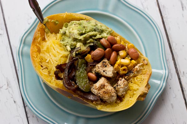 These Chicken Burrito Spaghetti Squash Bowls are protein packed and gluten free. I love this veggie filled take on this popular Mexican dish. Everything is better in a {spaghetti squash} bowl!