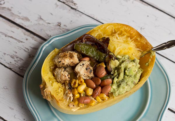 These Chicken Burrito Spaghetti Squash Bowls are protein packed and gluten free. I love this veggie filled take on this popular Mexican dish. Everything is better in a {spaghetti squash} bowl!