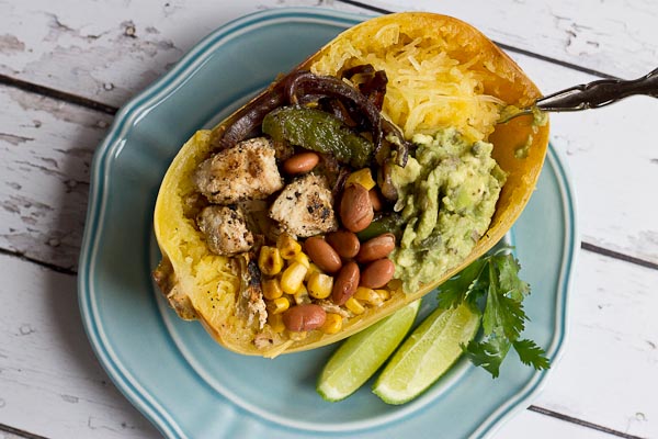 These Chicken Burrito Spaghetti Squash Bowls are protein packed and gluten free. I love this veggie filled take on this popular Mexican dish. Everything is better in a {spaghetti squash} bowl!