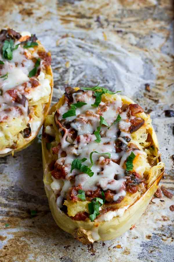 These Vegetarian Lasagna Spaghetti Squash Boats will rock your world. It's super filling and each boat is packed with several cups of mushrooms, onions, and spinach! Talk about veggie-fied. You're going to love this lower carb and meatless take on lasagna that will satisfy that pasta craving.