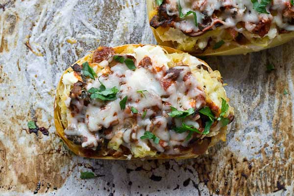 These Vegetarian Lasagna Spaghetti Squash Boats will rock your world. It's super filling and each boat is packed with several cups of mushrooms, onions, and spinach! Talk about veggie-fied. You're going to love this lower carb and meatless take on lasagna that will satisfy that pasta craving.