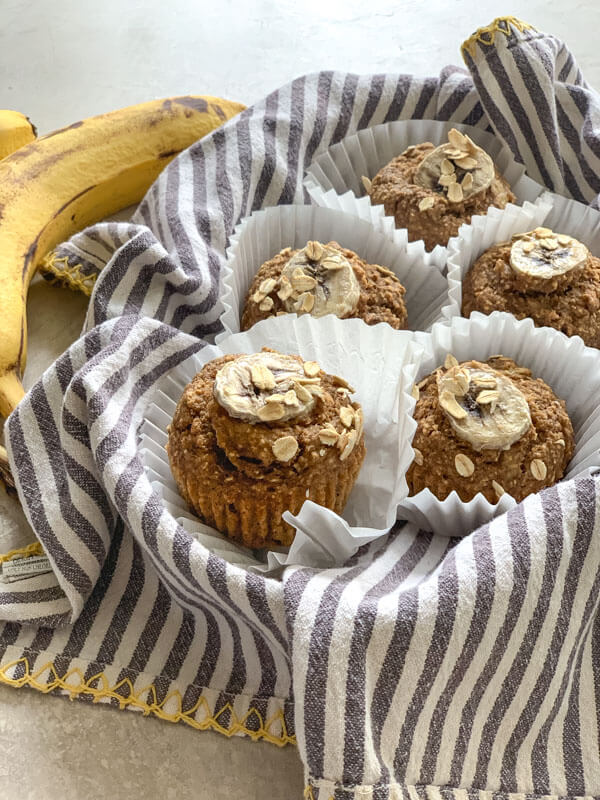 These Banana Oatmeal Muffins are moist, healthy and oil free applesauce muffins with a delicious cinnamon banana flavor. Easy gluten free muffins made with oat flour!