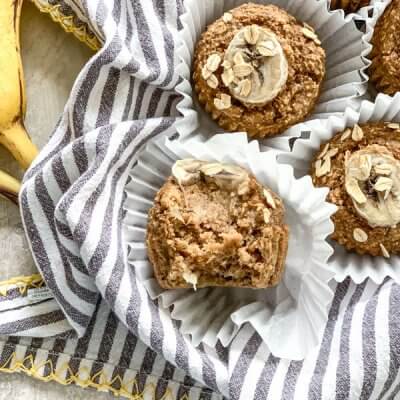 These Banana Oatmeal Muffins are moist, healthy and oil free applesauce muffins with a delicious cinnamon banana flavor. Easy gluten free muffins made with oat flour!