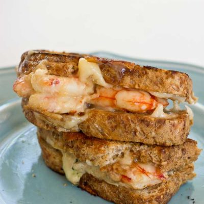 This Shrimp Grilled Cheese doesn't hold anything back-- melted cheddar cheese, buttered toast, and large grilled shrimp. Let loose, unwind and savor this comfort food any night of the week.