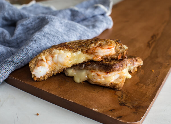 This Shrimp Grilled Cheese doesn't hold anything back-- melted cheddar cheese, buttered toast, and large grilled shrimp. Let loose, unwind and savor this comfort food any night of the week. 