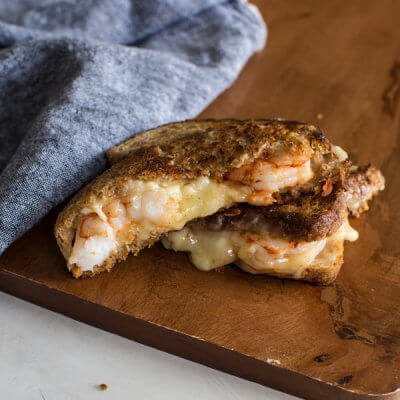 This Shrimp Grilled Cheese doesn't hold anything back-- melted cheddar cheese, buttered toast, and large grilled shrimp. Let loose, unwind and savor this comfort food any night of the week.