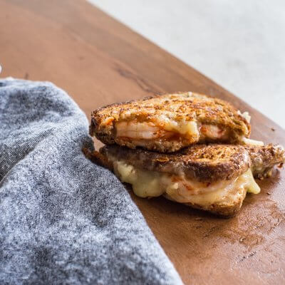 This Shrimp Grilled Cheese doesn't hold anything back-- melted cheddar cheese, buttered toast, and large grilled shrimp. Let loose, unwind and savor this comfort food any night of the week.