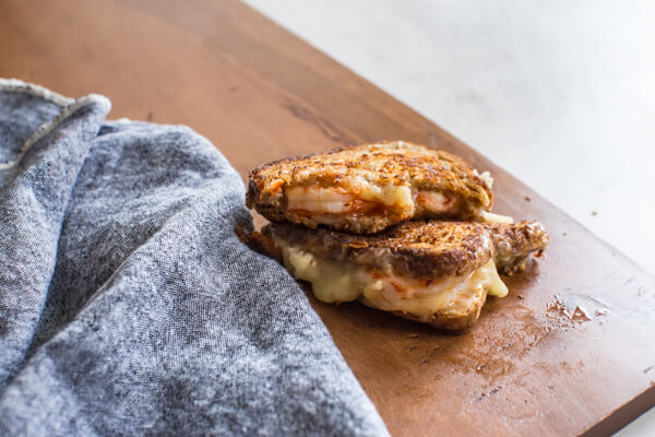 This Shrimp Grilled Cheese doesn't hold anything back-- melted cheddar cheese, buttered toast, and large grilled shrimp. Let loose, unwind and savor this comfort food any night of the week. 