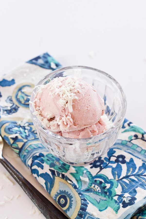 This Strawberry Coconut Ice Cream is so decadent and lusciously creamy! Grab a bowl of this vegan ice cream made with less refined sugar thanks to the sweetness of fresh strawberries and bananas.