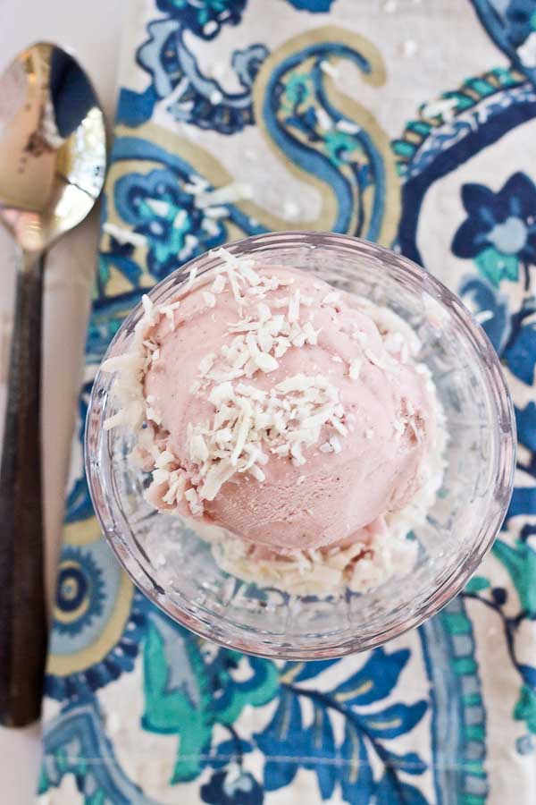 This Strawberry Coconut Ice Cream is so decadent and lusciously creamy! Grab a bowl of this vegan ice cream made with less refined sugar thanks to the sweetness of fresh strawberries and bananas.