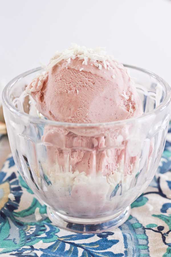 This Strawberry Coconut Ice Cream is so decadent and lusciously creamy! Grab a bowl of this vegan ice cream made with less refined sugar thanks to the sweetness of fresh strawberries and bananas.