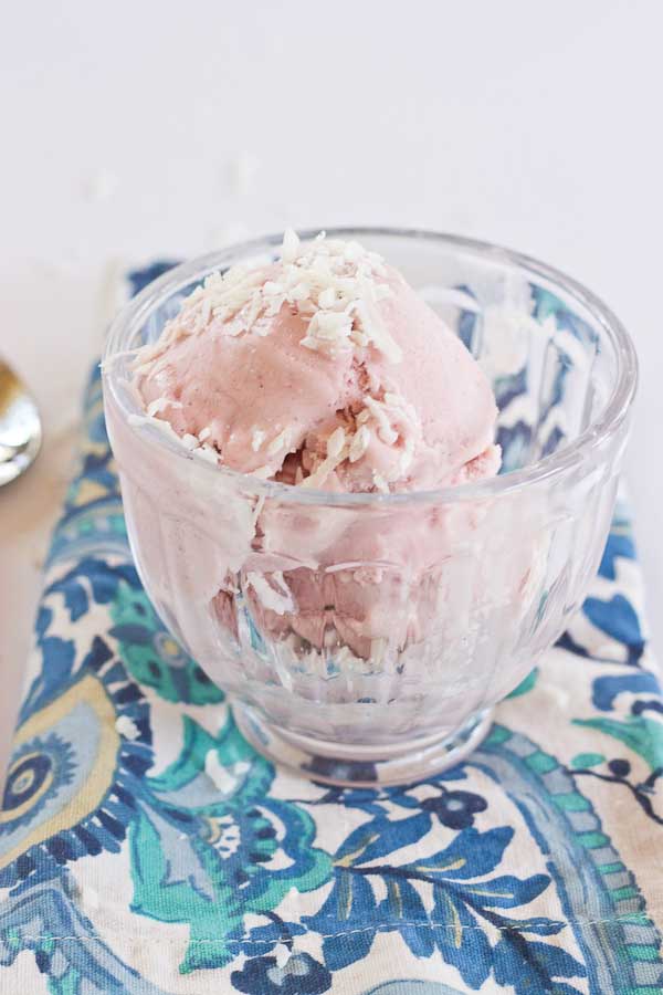 This Strawberry Coconut Ice Cream is so decadent and lusciously creamy! Grab a bowl of this vegan ice cream made with less refined sugar thanks to the sweetness of fresh strawberries and bananas.