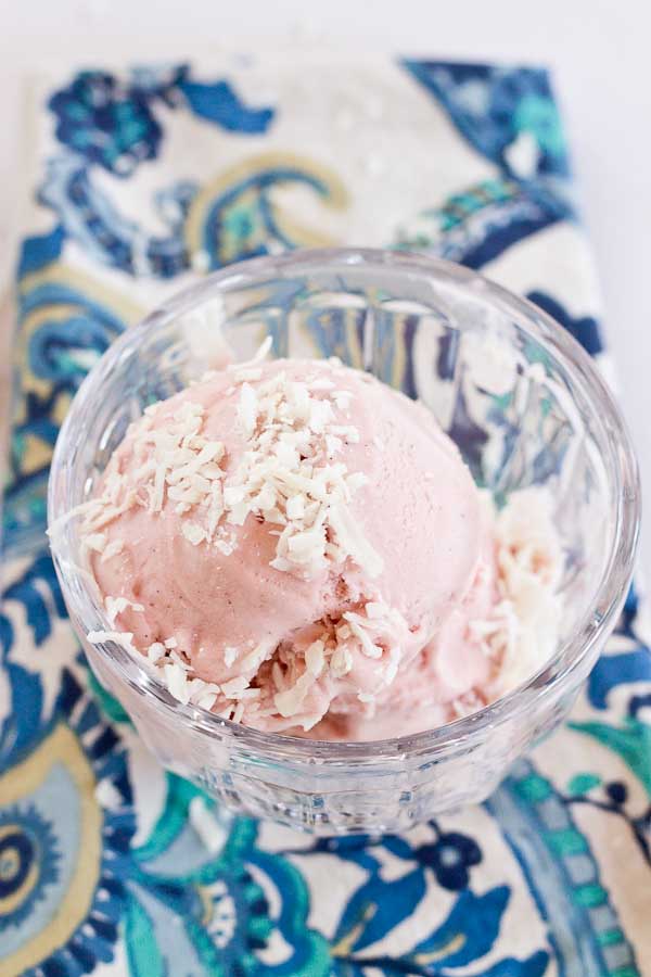 This Strawberry Coconut Ice Cream is so decadent and lusciously creamy! Grab a bowl of this vegan ice cream made with less refined sugar thanks to the sweetness of fresh strawberries and bananas.