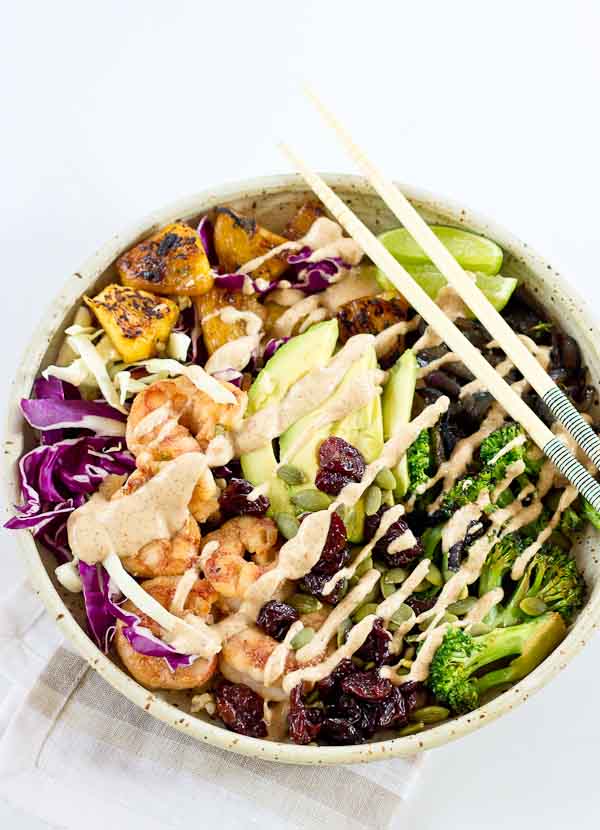 This Tropical Buddha Bowl is infused with island flavor from the Coconut Brown Rice to the Almond Butter Lime dressing. Perfectly grilled shrimp, pineapple, tart cherries, and a bowl full of veggies! It’s great for meal prep.