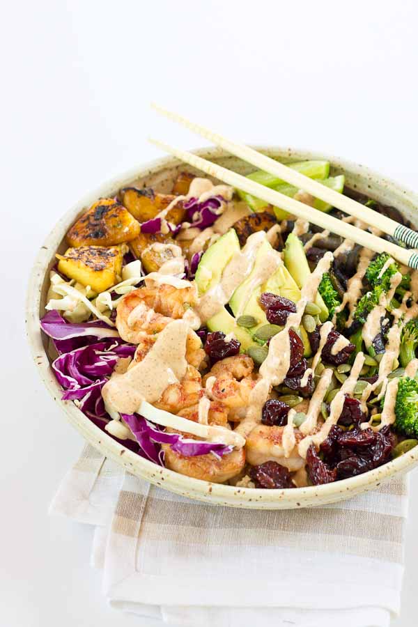 This Tropical Buddha Bowl is infused with island flavor from the Coconut Brown Rice to the Almond Butter Lime dressing. Perfectly grilled shrimp, pineapple, tart cherries, and a bowl full of veggies! It’s great for meal prep.