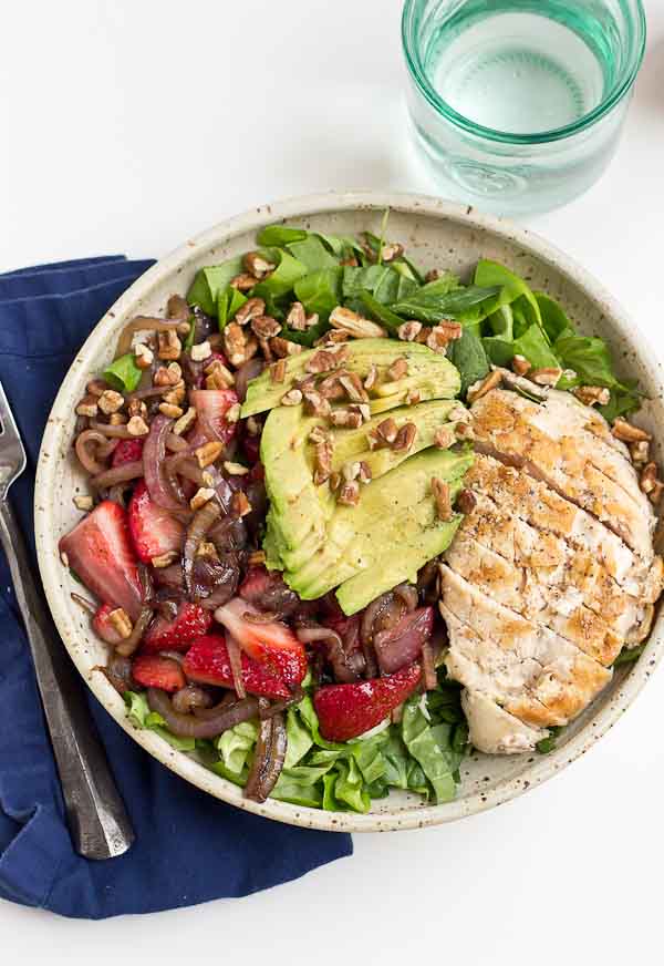 This Strawberry Balsamic Grilled Chicken Salad is light, crisp and perfect for summertime eating. The warm chicken and balsamic strawberries and onions add so much flavor to this salad. You're' going to love it!