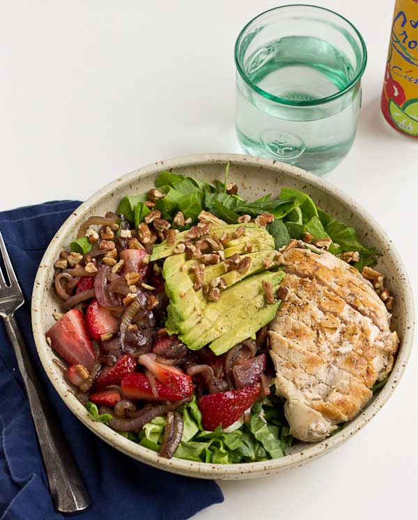 This Strawberry Balsamic Grilled Chicken Salad is light, crisp and perfect for summertime eating. The warm chicken and balsamic strawberries and onions add so much flavor to this salad. You're' going to love it!