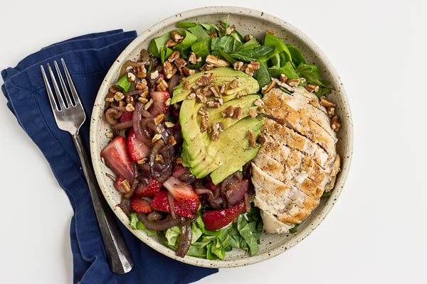 This Strawberry Balsamic Grilled Chicken Salad is light, crisp and perfect for summertime eating. The warm chicken and balsamic strawberries and onions add so much flavor to this salad. You're' going to love it!