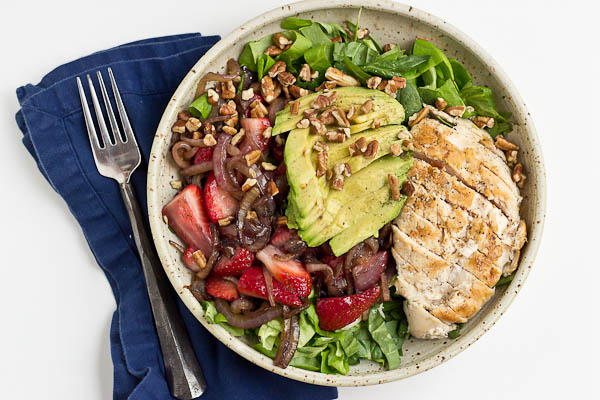 This Strawberry Balsamic Grilled Chicken Salad is light, crisp and perfect for summertime eating. The warm chicken and balsamic strawberries and onions add so much flavor to this salad. You're' going to love it!