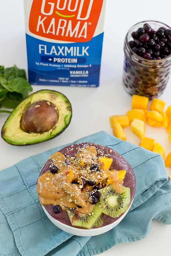 With summer quickly approaching, this superfood smoothie bowl will keep you cool and fueled on the sunniest days. Wild blueberries, spinach, avocado, and flaxmilk combine to form a creamy, antioxidant-packed bowl that is vegan and gluten-free! Slices of fresh kiwi and a drizzle of almond butter make this smoothie bowl practically irresistible.