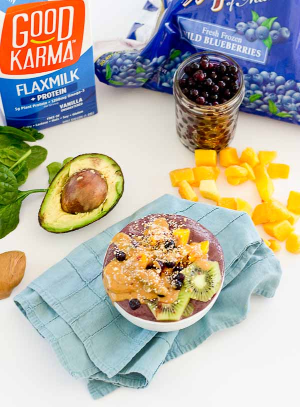 With summer quickly approaching, this superfood smoothie bowl will keep you cool and fueled on the sunniest days. Wild blueberries, spinach, avocado, and flaxmilk combine to form a creamy, antioxidant-packed bowl that is vegan and gluten-free! Slices of fresh kiwi and a drizzle of almond butter make this smoothie bowl practically irresistible.